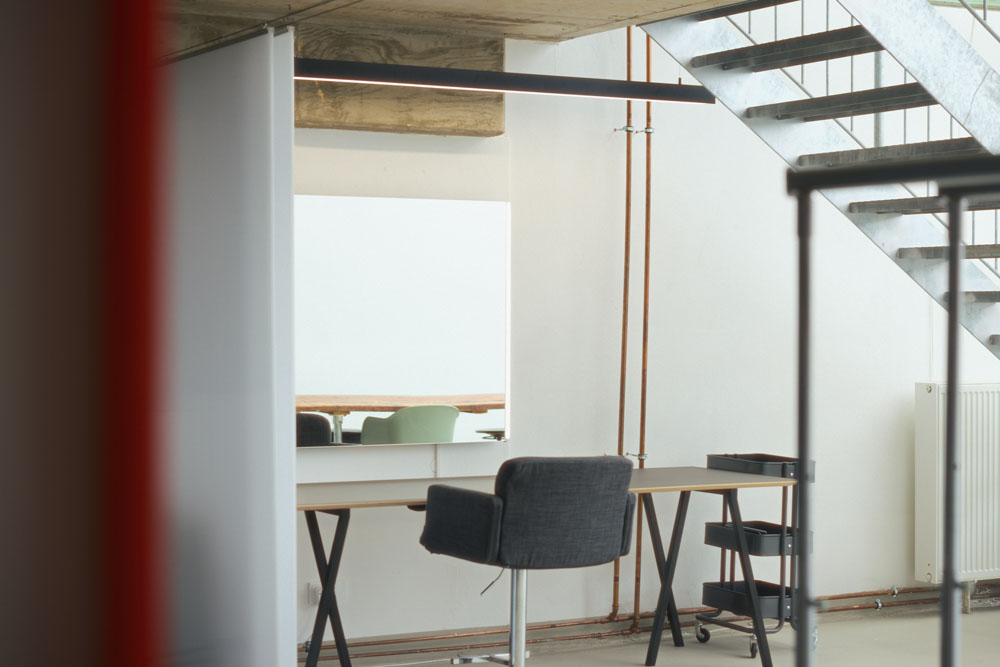 Make-up station with mirror and lighting under the stairs